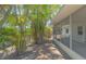 Covered and screened porch area off a well-kept home with mature trees, adding privacy and charm to the outdoor space at 5522 Calle Del Verano, Sarasota, FL 34242