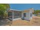 View of the screened-in porch with a lawn and house exterior at 5522 Calle Del Verano, Sarasota, FL 34242