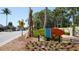 Landscaped Siesta Key Village sign on a sunny day, welcoming visitors to the area and nearby shops at 5522 Calle Del Verano, Sarasota, FL 34242