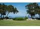 Expansive lawn and lush trees create a private retreat with serene water views and a sense of tranquility at 600 Manatee Ave # 143, Holmes Beach, FL 34217