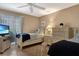 Bright bedroom with two twin beds, dressers, and a sliding door to the outdoor space at 600 Manatee Ave # 143, Holmes Beach, FL 34217