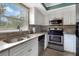 Modern kitchen with stainless steel appliances, granite countertops, and bright natural light at 600 Manatee Ave # 143, Holmes Beach, FL 34217