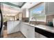 Bright kitchen features granite countertops, stainless sink, and plenty of cabinet space at 600 Manatee Ave # 143, Holmes Beach, FL 34217