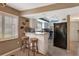 Open concept kitchen with breakfast bar seating, granite countertops and stainless appliances at 600 Manatee Ave # 143, Holmes Beach, FL 34217