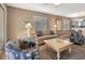 Comfortable living room features coastal decor, tile floors, and access to a screened lanai at 600 Manatee Ave # 143, Holmes Beach, FL 34217