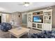 Spacious living room with built-in entertainment center, coastal decor and tile flooring at 600 Manatee Ave # 143, Holmes Beach, FL 34217