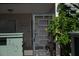 Inviting patio entrance with a unique geometric screen door and lush flowering plants at 600 Manatee Ave # 143, Holmes Beach, FL 34217