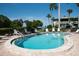 Outdoor pool featuring inviting lounge chairs, surrounded by lush landscaping on a clear sunny day at 600 Manatee Ave # 143, Holmes Beach, FL 34217