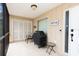 Relaxing screened patio featuring tile floors, a grill, seating, and closet storage at 600 Manatee Ave # 143, Holmes Beach, FL 34217