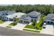 Aerial view of a two-story home with a three-car garage, manicured lawn, and mature landscaping at 6017 Maidenstone Way, Palmetto, FL 34221