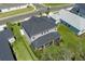Birds eye view of the property featuring a well-manicured lawn and a screened-in outdoor living area at 6017 Maidenstone Way, Palmetto, FL 34221