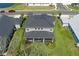 Aerial view of the property highlighting the large backyard with screened patio and lush landscaping at 6017 Maidenstone Way, Palmetto, FL 34221