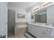 Bright bathroom with double vanity, soaking tub, and glass-enclosed shower at 6017 Maidenstone Way, Palmetto, FL 34221