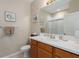 Bathroom featuring framed art, towels, white countertops, and a shower behind sliding glass doors at 6017 Maidenstone Way, Palmetto, FL 34221