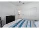 Bright bedroom featuring a blue striped comforter, dresser, and closet with sliding doors at 6017 Maidenstone Way, Palmetto, FL 34221