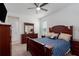 A primary bedroom with neutral walls, carpeting, a fan, a TV and a nice dresser at 6017 Maidenstone Way, Palmetto, FL 34221