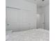 Bright bedroom featuring white bedding, closet with sliding doors, and views to the hallway at 6017 Maidenstone Way, Palmetto, FL 34221