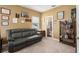 Cozy bedroom features a comfortable leather sofa and decorative elements at 6017 Maidenstone Way, Palmetto, FL 34221