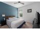 Bedroom features a striking blue accent wall and views of nature at 6017 Maidenstone Way, Palmetto, FL 34221