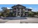 Exterior of community clubhouse with stone accents, covered balconies, and well-manicured landscaping at 6017 Maidenstone Way, Palmetto, FL 34221