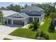 Beautiful two-story home showcasing a three-car garage and a well-manicured lawn at 6017 Maidenstone Way, Palmetto, FL 34221