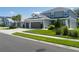 Charming home featuring a three-car garage, lush lawn, and well maintained landscaping at 6017 Maidenstone Way, Palmetto, FL 34221