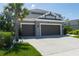 Spacious three-car garage, ample driveway and lovely landscaping create curb appeal at 6017 Maidenstone Way, Palmetto, FL 34221