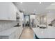 Well-lit kitchen boasts sleek white cabinetry, stainless steel appliances, and a spacious counter-top area at 6017 Maidenstone Way, Palmetto, FL 34221