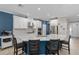Bright kitchen with a blue accent wall, white cabinets, stainless steel appliances, and a large center island at 6017 Maidenstone Way, Palmetto, FL 34221