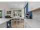 Bright kitchen features stainless appliances, white cabinets, and eat-in dining area at 6017 Maidenstone Way, Palmetto, FL 34221