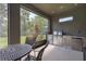 Outdoor kitchen featuring stainless steel appliances, countertops, and outdoor dining area with seating at 6017 Maidenstone Way, Palmetto, FL 34221