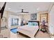 Cozy bedroom with a ceiling fan, and large windows showcasing the outdoor landscape at 6412 Sun Eagle Ln, Bradenton, FL 34210