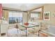 Dining room with a glass-top table, modern chairs, and a bright window at 6412 Sun Eagle Ln, Bradenton, FL 34210