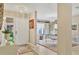 Foyer featuring travertine floors, chandelier, and views of the dining room at 6412 Sun Eagle Ln, Bradenton, FL 34210