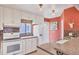 This bright kitchen features white cabinets, a window above the sink, and striking tile backsplash at 6412 Sun Eagle Ln, Bradenton, FL 34210