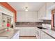 This well-lit kitchen showcases white cabinets, tile backsplash, and granite countertops at 6412 Sun Eagle Ln, Bradenton, FL 34210
