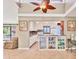 Open kitchen design with sleek white cabinetry, modern appliances, and adjacent living area at 6412 Sun Eagle Ln, Bradenton, FL 34210