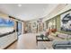 Bright living room featuring an open floor plan, tile floors, and sliding glass doors at 6412 Sun Eagle Ln, Bradenton, FL 34210