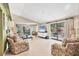 Spacious living room with vaulted ceilings, tile floors, and sliding glass doors to the patio at 6412 Sun Eagle Ln, Bradenton, FL 34210