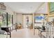 Bright living room featuring tile floors, comfortable seating, and large windows with views of the tropical landscaping at 6412 Sun Eagle Ln, Bradenton, FL 34210