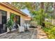 A cozy patio area features a round table with white chairs, perfect for outdoor dining or relaxation at 6412 Sun Eagle Ln, Bradenton, FL 34210