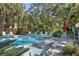 A lush pool area with lounge chairs surrounded by tropical landscaping at 6412 Sun Eagle Ln, Bradenton, FL 34210