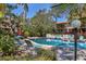 A serene pool area features comfortable lounge chairs and lush tropical foliage creating a relaxing oasis at 6412 Sun Eagle Ln, Bradenton, FL 34210