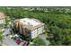 Enjoy a beautiful aerial view of this multi-story condo surrounded by lush green trees at 6465 Watercrest Way # 404, Lakewood Ranch, FL 34202