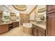 Elegant bathroom featuring a tub, walk-in shower, custom cabinets, and granite countertops at 6465 Watercrest Way # 404, Lakewood Ranch, FL 34202