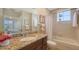 Bright bathroom showcases granite countertops and a shower-tub combination at 6465 Watercrest Way # 404, Lakewood Ranch, FL 34202