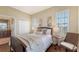 Serene bedroom featuring plantation shutters, wood floors, and calming neutral tones at 6465 Watercrest Way # 404, Lakewood Ranch, FL 34202