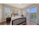 Inviting bedroom boasts wood floors, plantation shutters, and access to a private balcony at 6465 Watercrest Way # 404, Lakewood Ranch, FL 34202