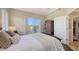 Cozy bedroom with a wardrobe, window, and access to a private balcony at 6465 Watercrest Way # 404, Lakewood Ranch, FL 34202