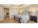 Calm bedroom with hardwood floors, tray ceilings, and decorative wall art at 6465 Watercrest Way # 404, Lakewood Ranch, FL 34202